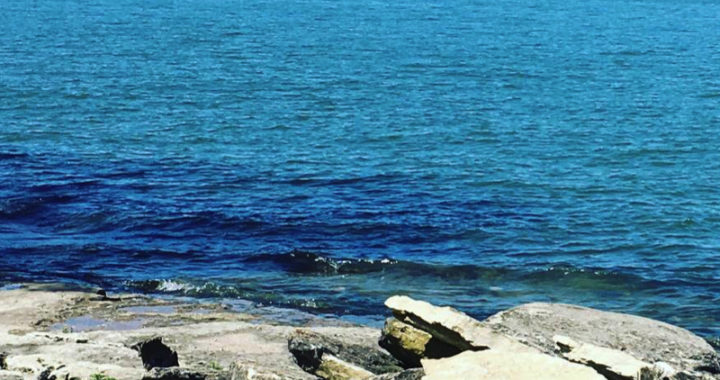 view of lake from rocky shore