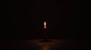 candle on table in darkness